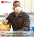 Person wearing 3M 8233 safety gear including mask, goggles, and gloves in a work setting.